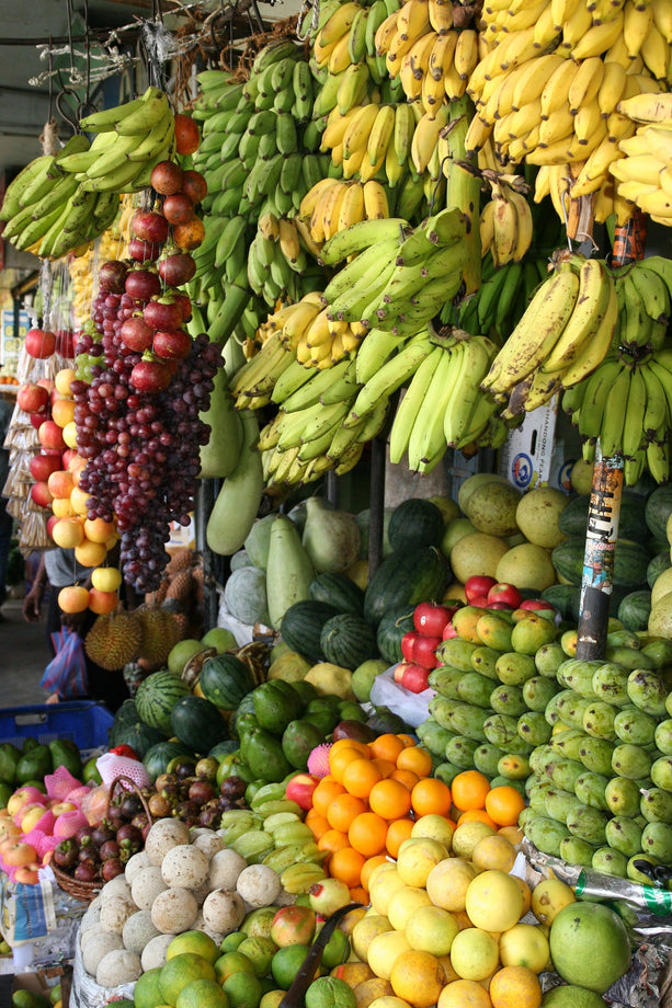 A market with a variety of arranged fruits, which are full of probiotics and fiber