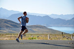 Man on a jog overlooking the moutains and lake