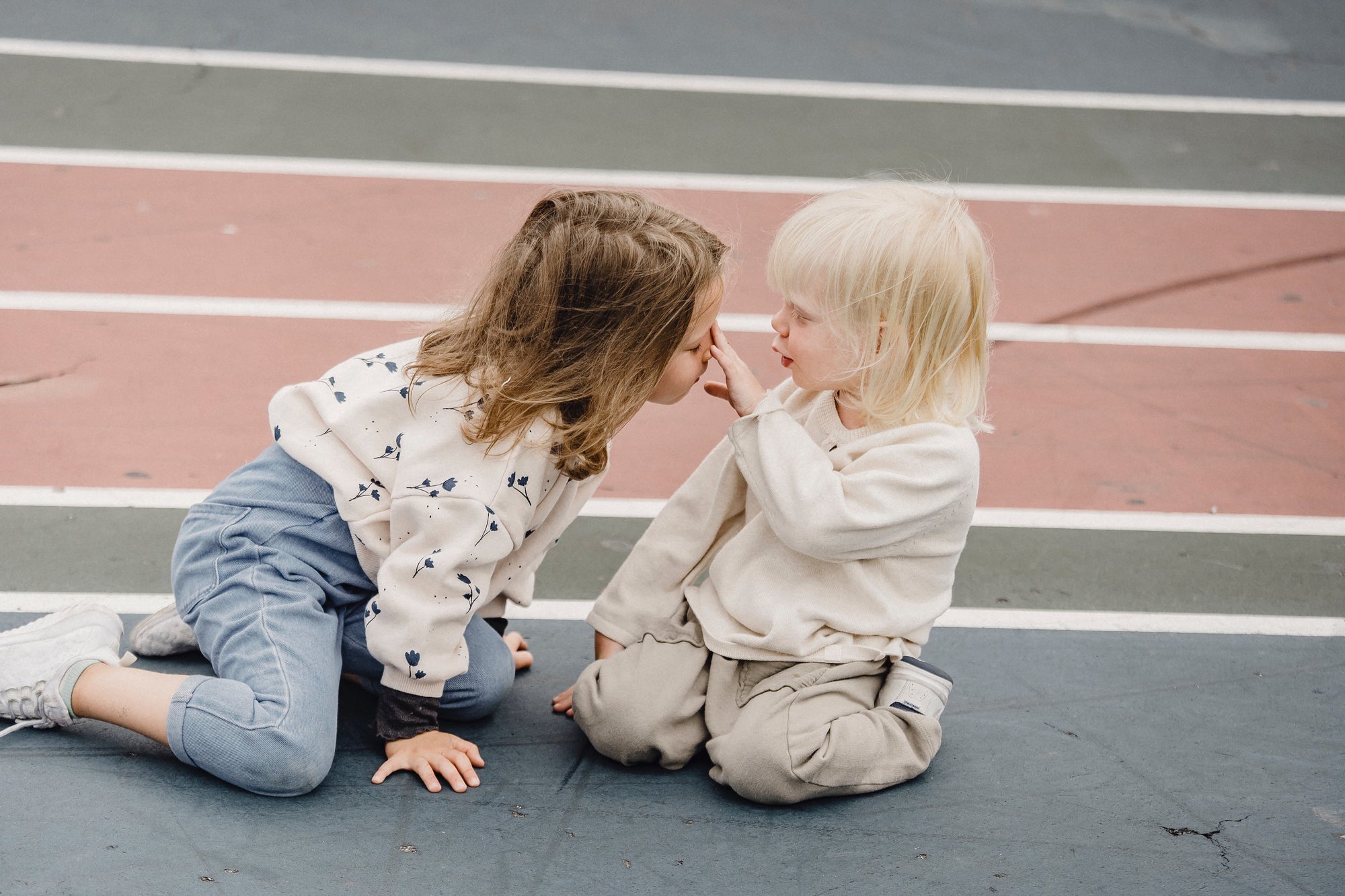 Two children playing on the playground floor