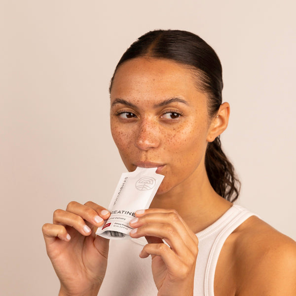 Woman drinking Cymbiotika Liposomal Creatine+