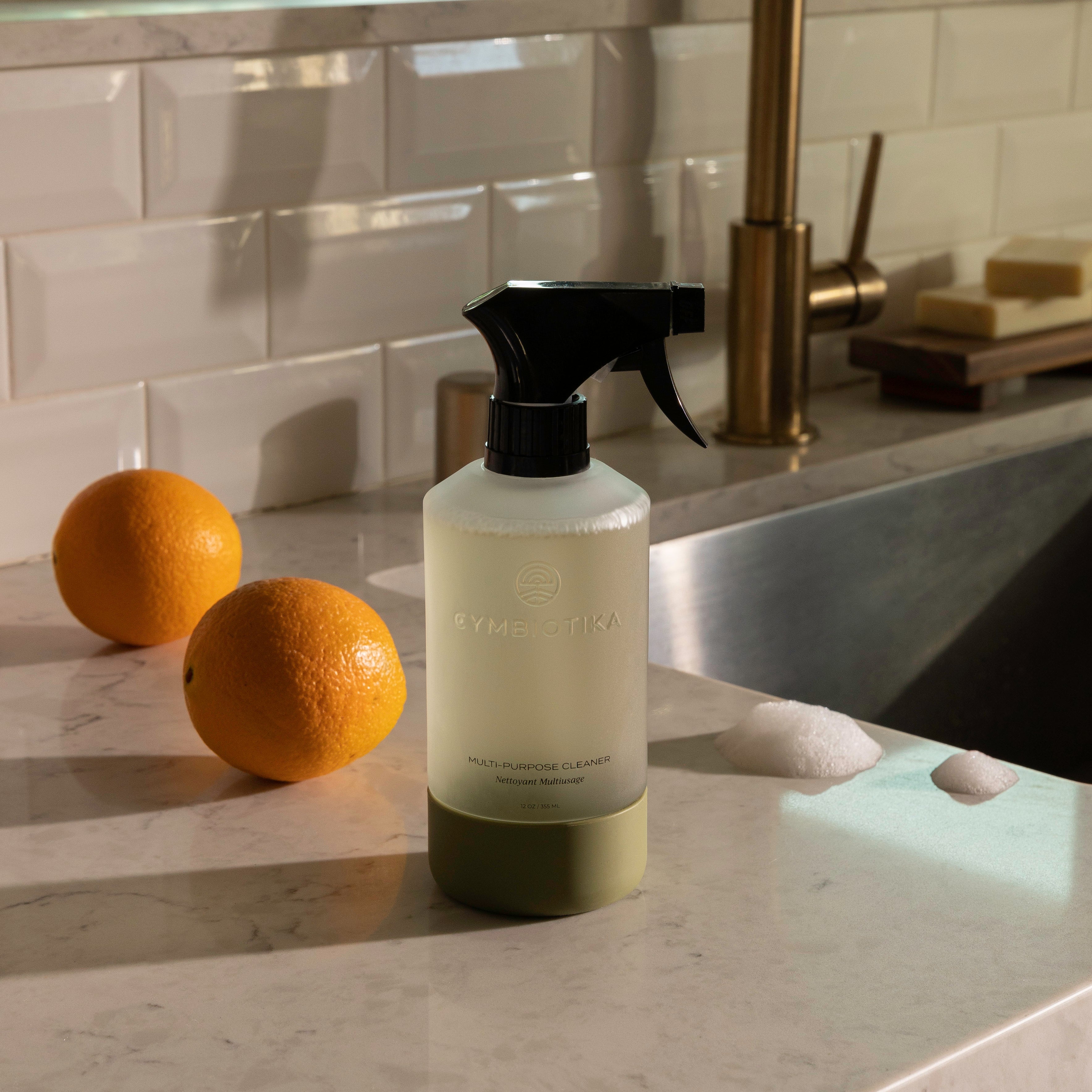 Multi-Purpose Cleaner Bottle On Counter next to Two Oranges